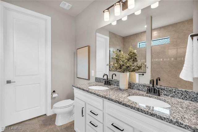 bathroom featuring toilet and vanity