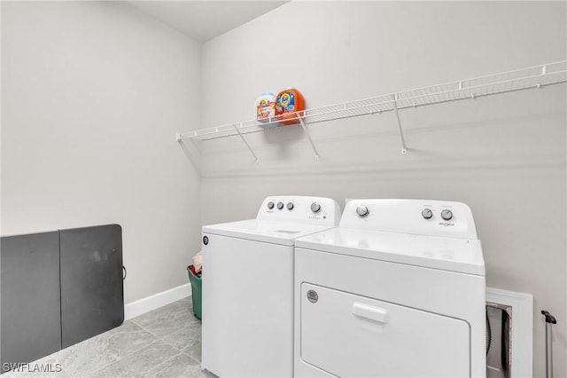 clothes washing area featuring washer and clothes dryer