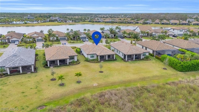 birds eye view of property with a water view