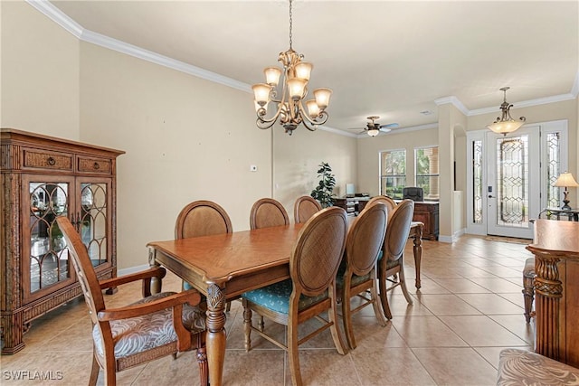 tiled dining area with ceiling fan with notable chandelier and crown molding