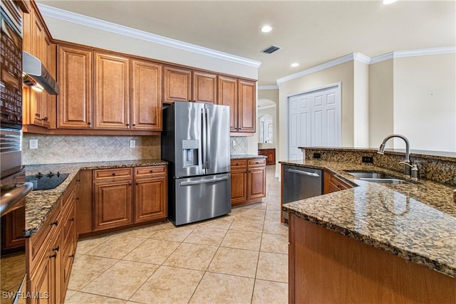 kitchen with light tile patterned floors, stainless steel appliances, dark stone countertops, and sink