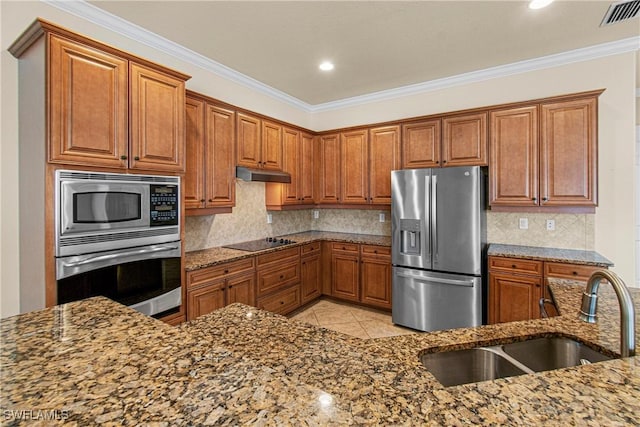 kitchen featuring appliances with stainless steel finishes, decorative backsplash, stone countertops, ornamental molding, and sink