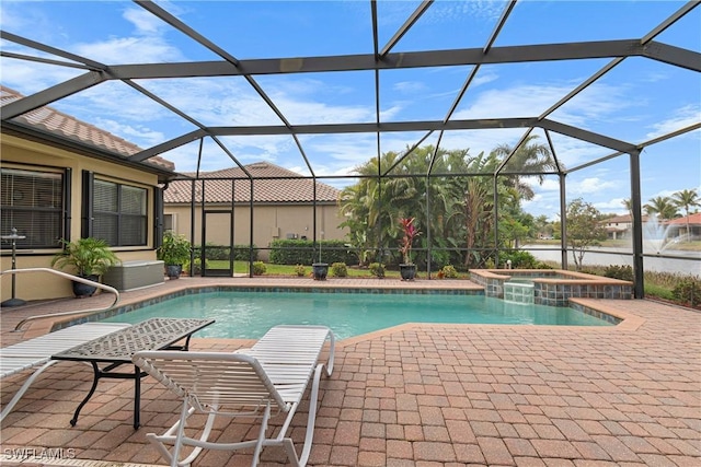 view of swimming pool featuring a patio area, glass enclosure, and an in ground hot tub