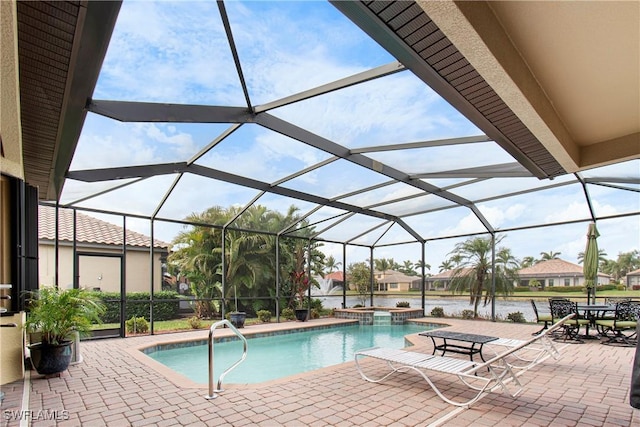 view of pool featuring a lanai, a water view, a patio, and an in ground hot tub