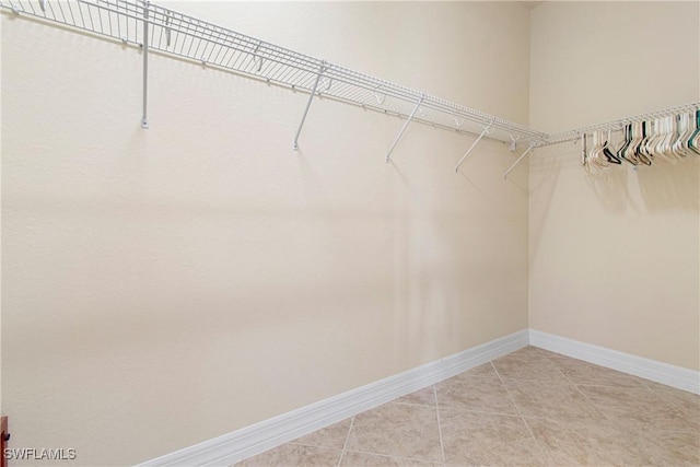 spacious closet featuring tile patterned flooring