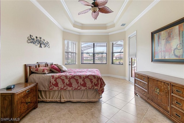 bedroom featuring ceiling fan, light tile patterned floors, a tray ceiling, and ornamental molding