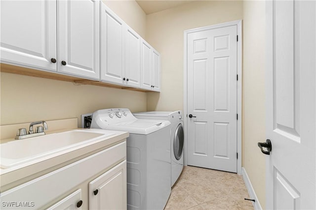 laundry room with washing machine and dryer, cabinets, light tile patterned floors, and sink