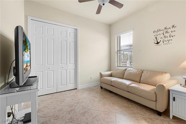 tiled living room featuring ceiling fan