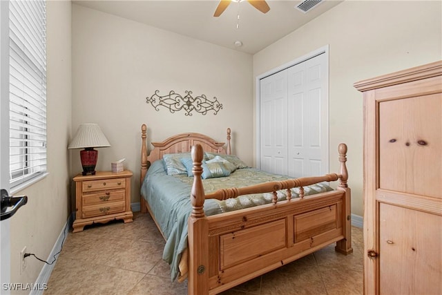 bedroom featuring ceiling fan, light tile patterned flooring, and a closet