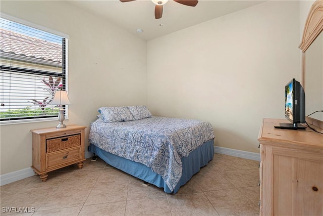 tiled bedroom featuring ceiling fan