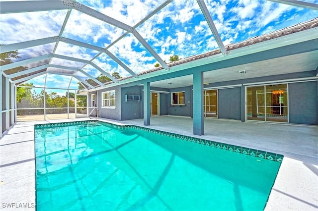 view of swimming pool with a patio, glass enclosure, and an AC wall unit