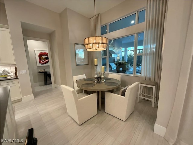 dining room with a notable chandelier and light tile patterned floors