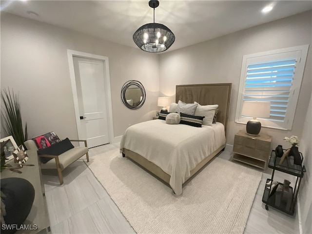 bedroom with a notable chandelier