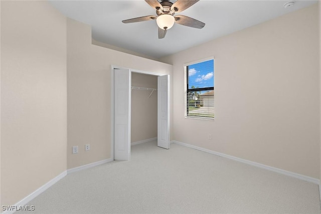 unfurnished bedroom featuring ceiling fan, light carpet, and a closet