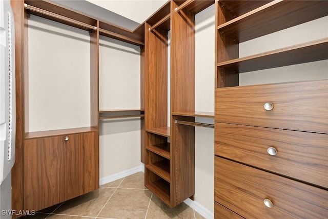 spacious closet with light tile patterned floors