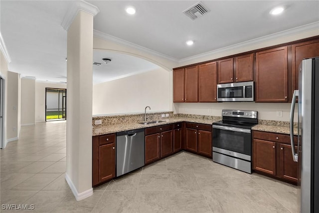 kitchen with light stone countertops, appliances with stainless steel finishes, ornamental molding, and sink