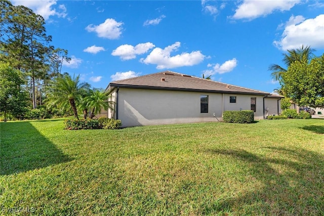 back of property featuring a lawn