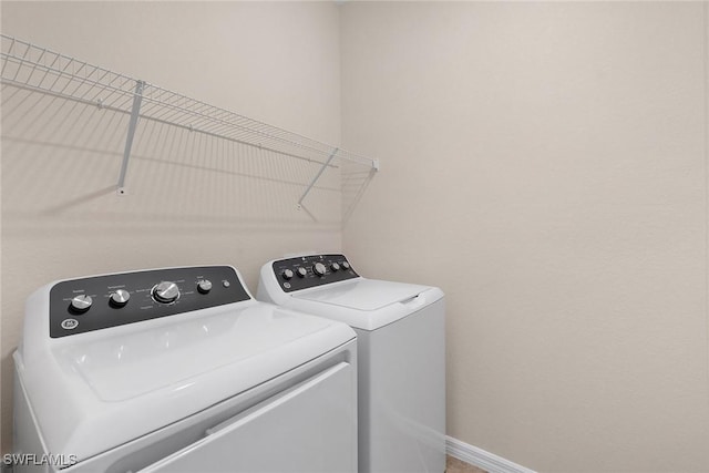 washroom with independent washer and dryer