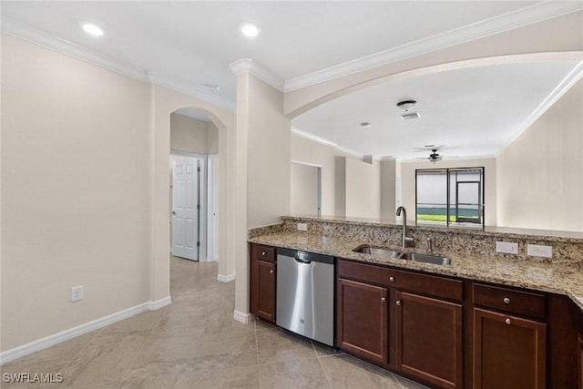 kitchen featuring dishwasher, arched walkways, a sink, and light stone countertops