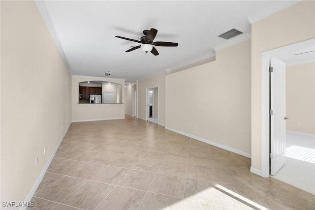 unfurnished living room with a ceiling fan, visible vents, crown molding, and baseboards