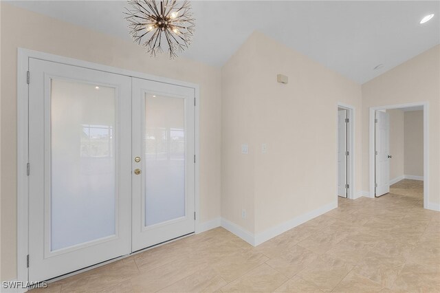 entryway featuring a chandelier and lofted ceiling