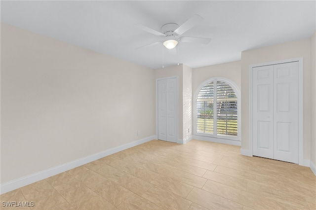 empty room featuring light tile patterned floors and ceiling fan