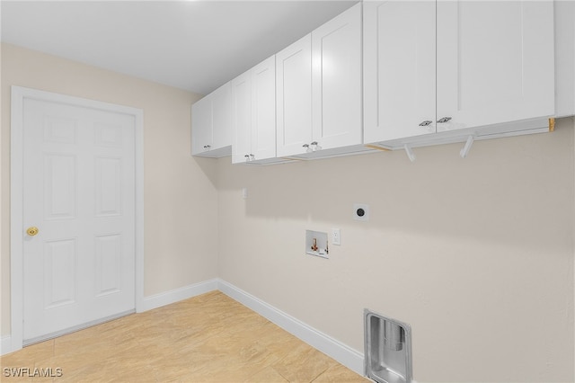 clothes washing area featuring washer hookup, electric dryer hookup, and cabinets