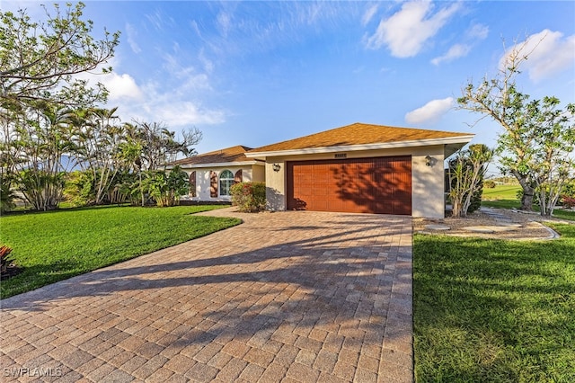 ranch-style home with a garage and a front lawn