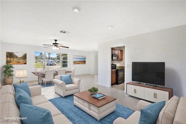 tiled living room with ceiling fan