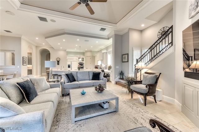 living room featuring ceiling fan, crown molding, and sink