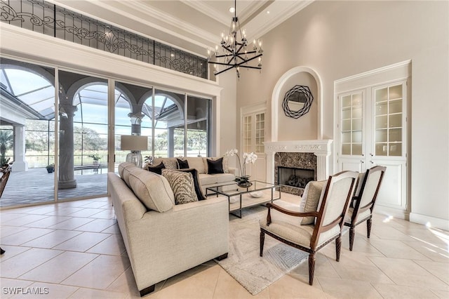 living room featuring a high end fireplace, a towering ceiling, crown molding, and light tile patterned floors