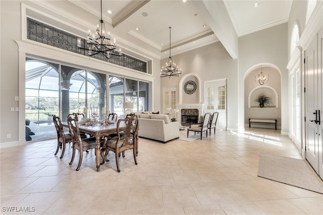 dining room featuring crown molding, a fireplace, and a high ceiling