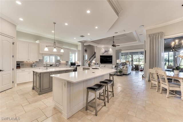 kitchen featuring a wealth of natural light, ceiling fan, a kitchen island, and pendant lighting