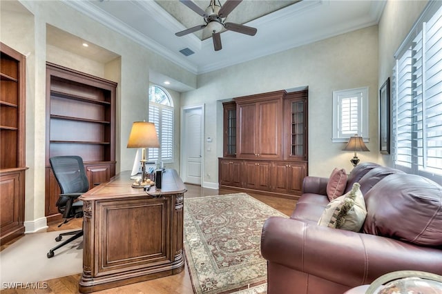 office space featuring ceiling fan, built in features, crown molding, and light hardwood / wood-style flooring