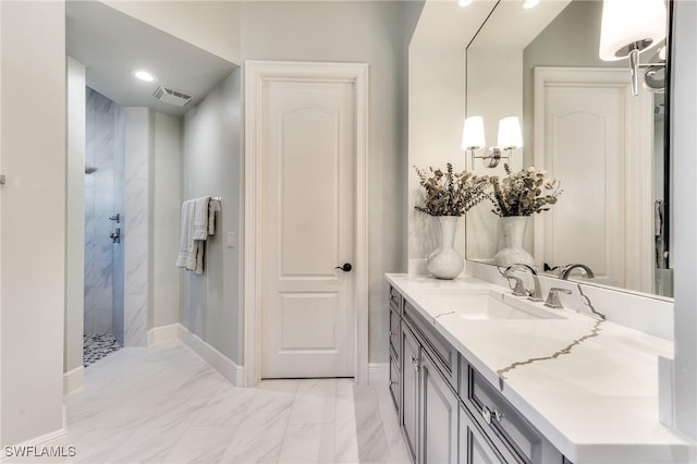 bathroom with vanity and tiled shower