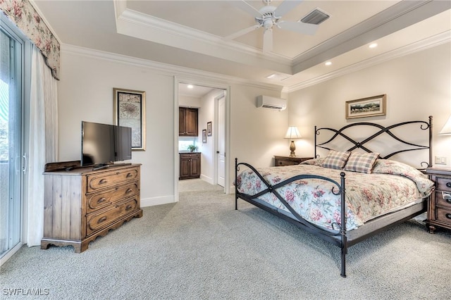 carpeted bedroom featuring a wall mounted air conditioner, ornamental molding, a raised ceiling, ceiling fan, and connected bathroom