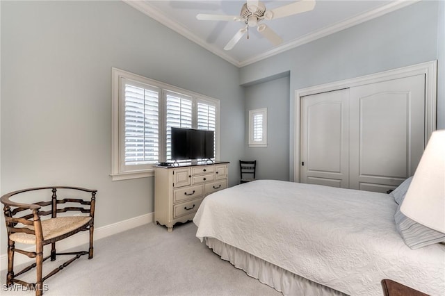 carpeted bedroom featuring ceiling fan, a closet, and ornamental molding