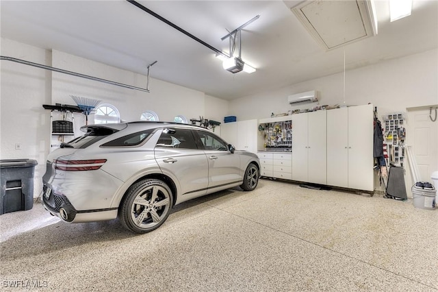 garage featuring an AC wall unit and a garage door opener