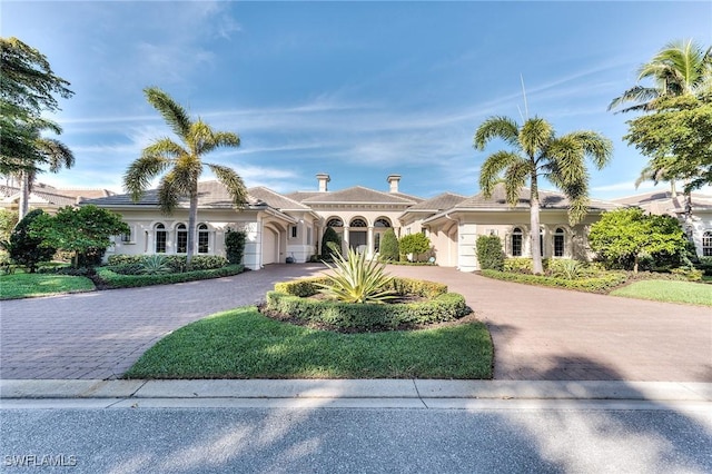 mediterranean / spanish-style home featuring a garage