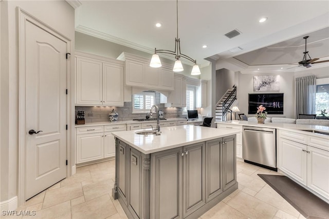 kitchen with dishwasher, pendant lighting, white cabinets, and a kitchen island with sink