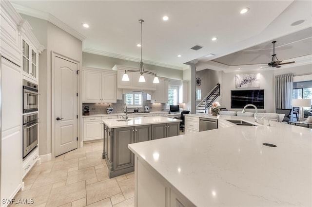 kitchen featuring gray cabinetry, white cabinets, decorative light fixtures, ceiling fan, and a large island