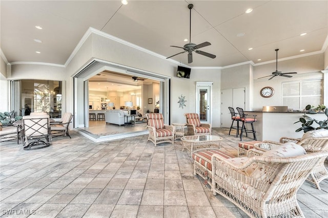 living room featuring ceiling fan and crown molding