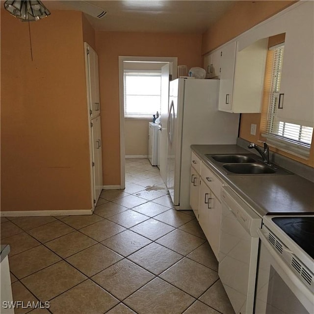 kitchen featuring white cabinets, light tile patterned floors, white appliances, and sink