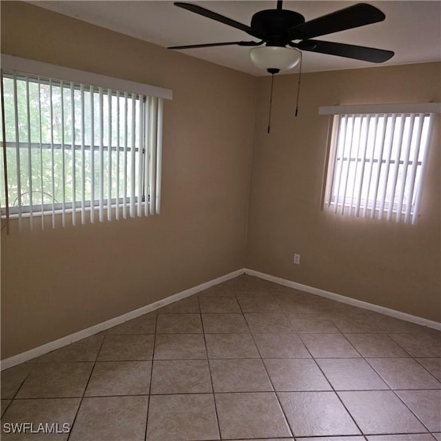 tiled empty room with ceiling fan