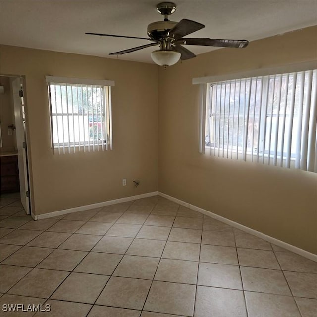 tiled empty room with ceiling fan