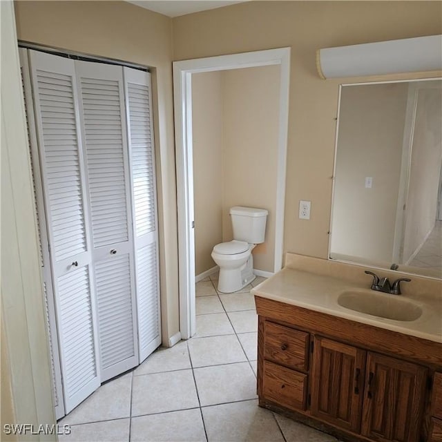 bathroom featuring tile patterned flooring, vanity, and toilet