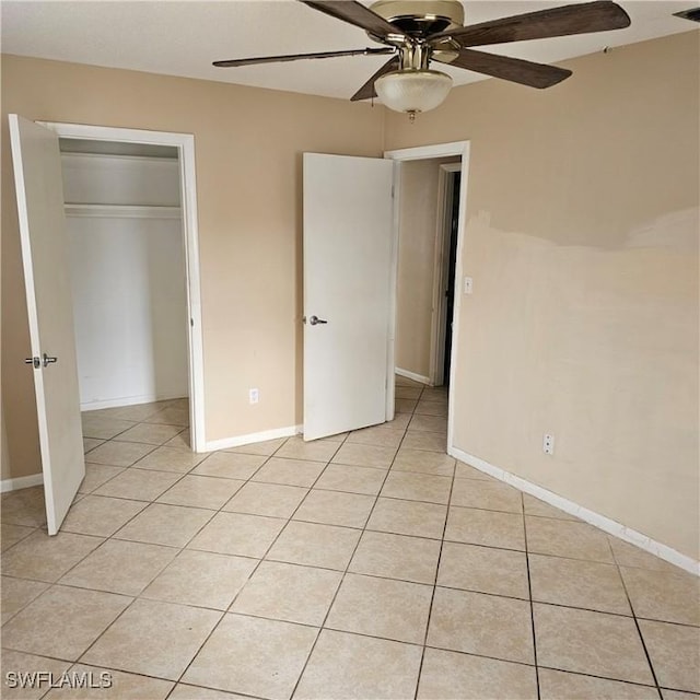 unfurnished bedroom featuring ceiling fan, a closet, and light tile patterned flooring