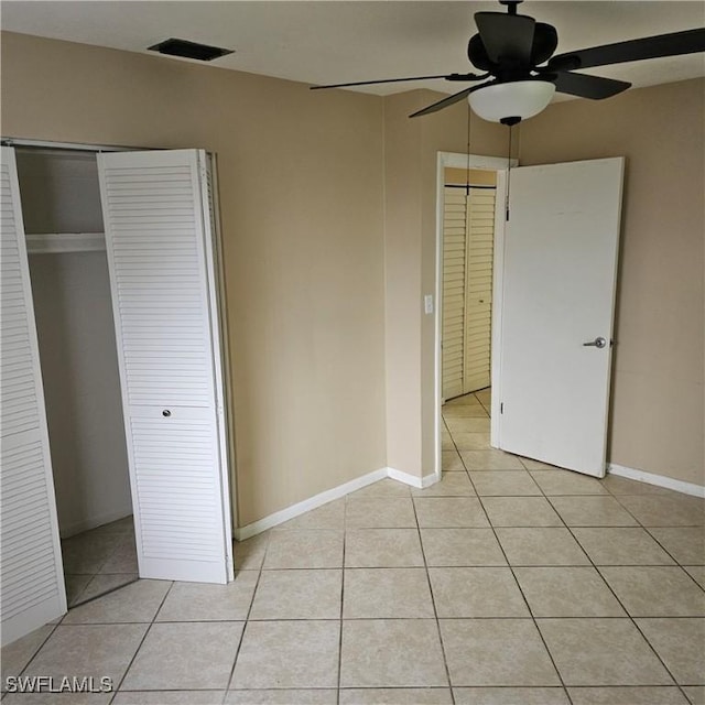 unfurnished bedroom with ceiling fan and light tile patterned floors