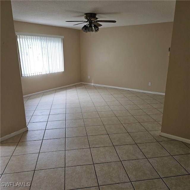 empty room featuring ceiling fan and light tile patterned flooring