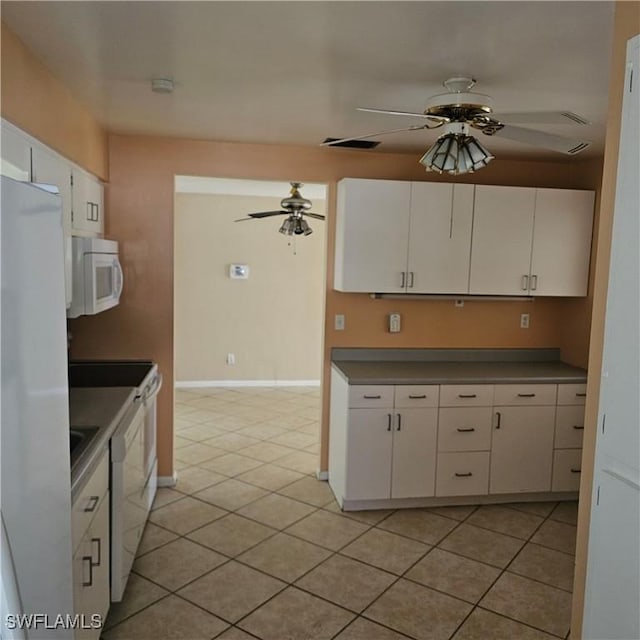 kitchen with white cabinets, light tile patterned floors, white appliances, and ceiling fan